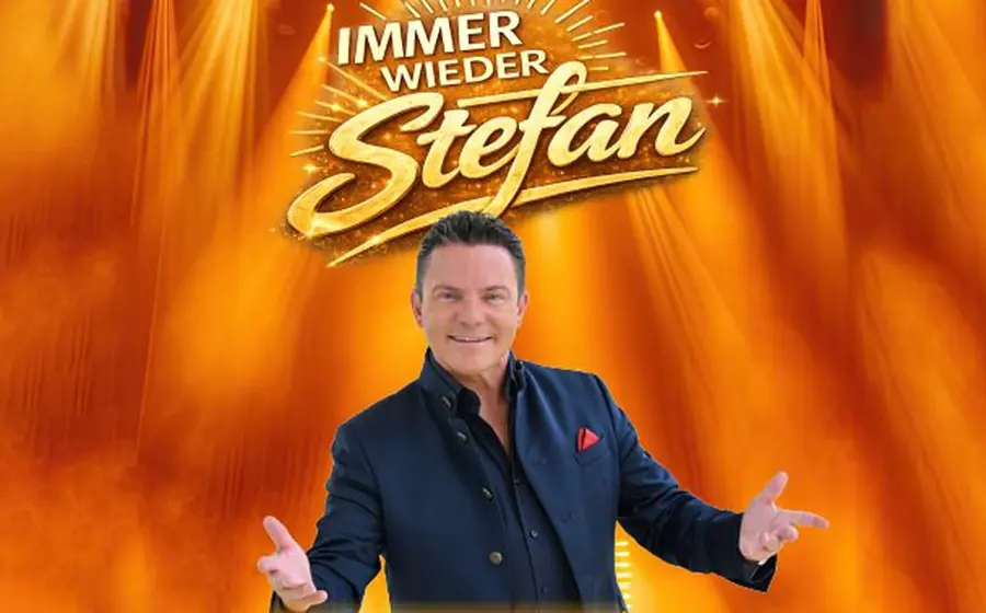 Plakat Immer wieder Stefan mit Stefan Mross in dunklem Sakko vor orangefarbenem Bühnenhintergrund mit Scheinwerfern, ausgebreiteten Armen und großem goldenen Schriftzug Immer wieder Stefan.