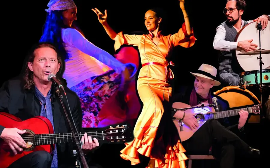 Flamenco-Tänzerinnen und Musiker mit Gitarre und Percussion bei einer leidenschaftlichen Bühnenperformance in farbenreicher Konzertbeleuchtung.